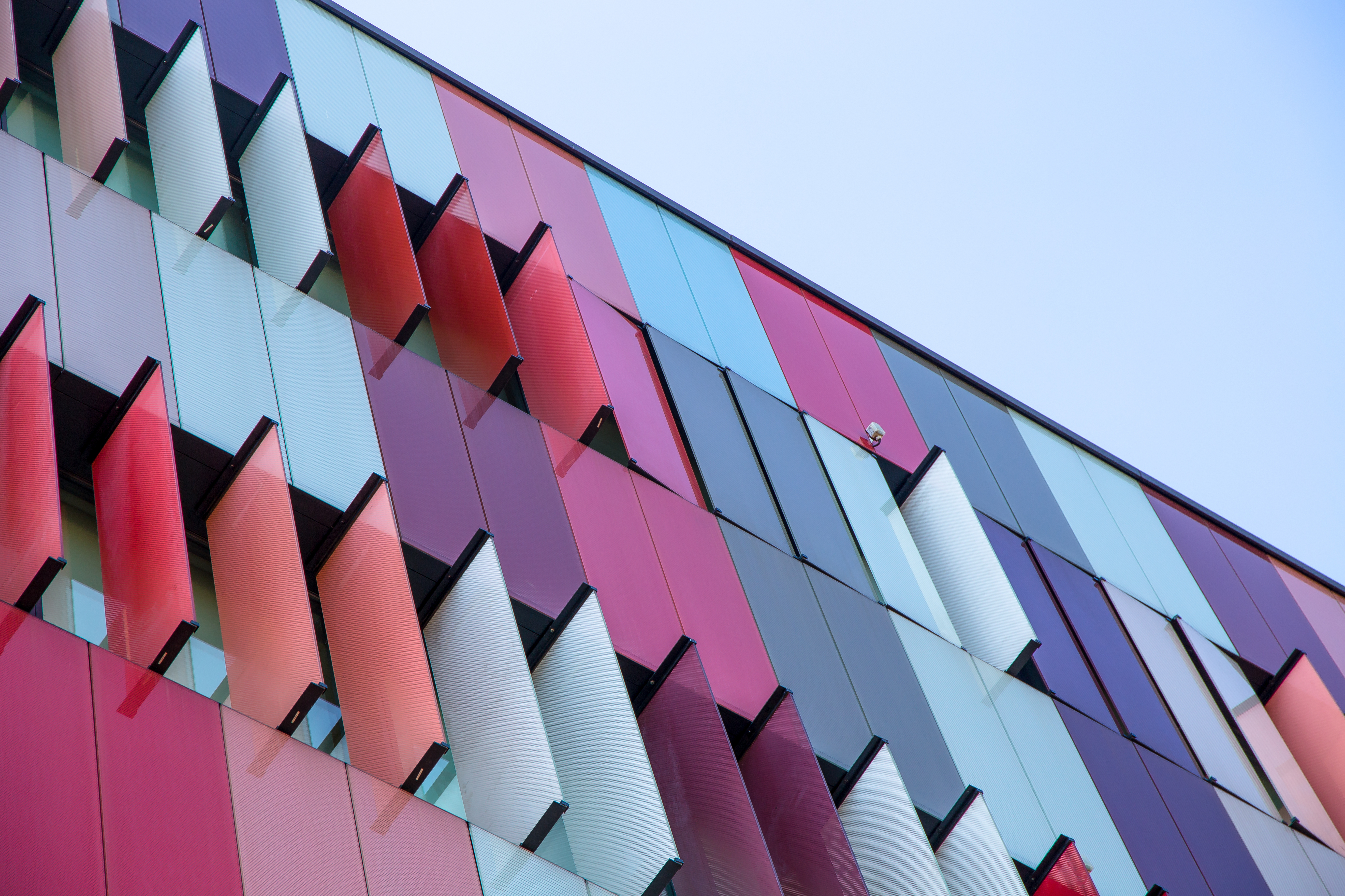Building covered in red, pink, blue and purple coloured elements