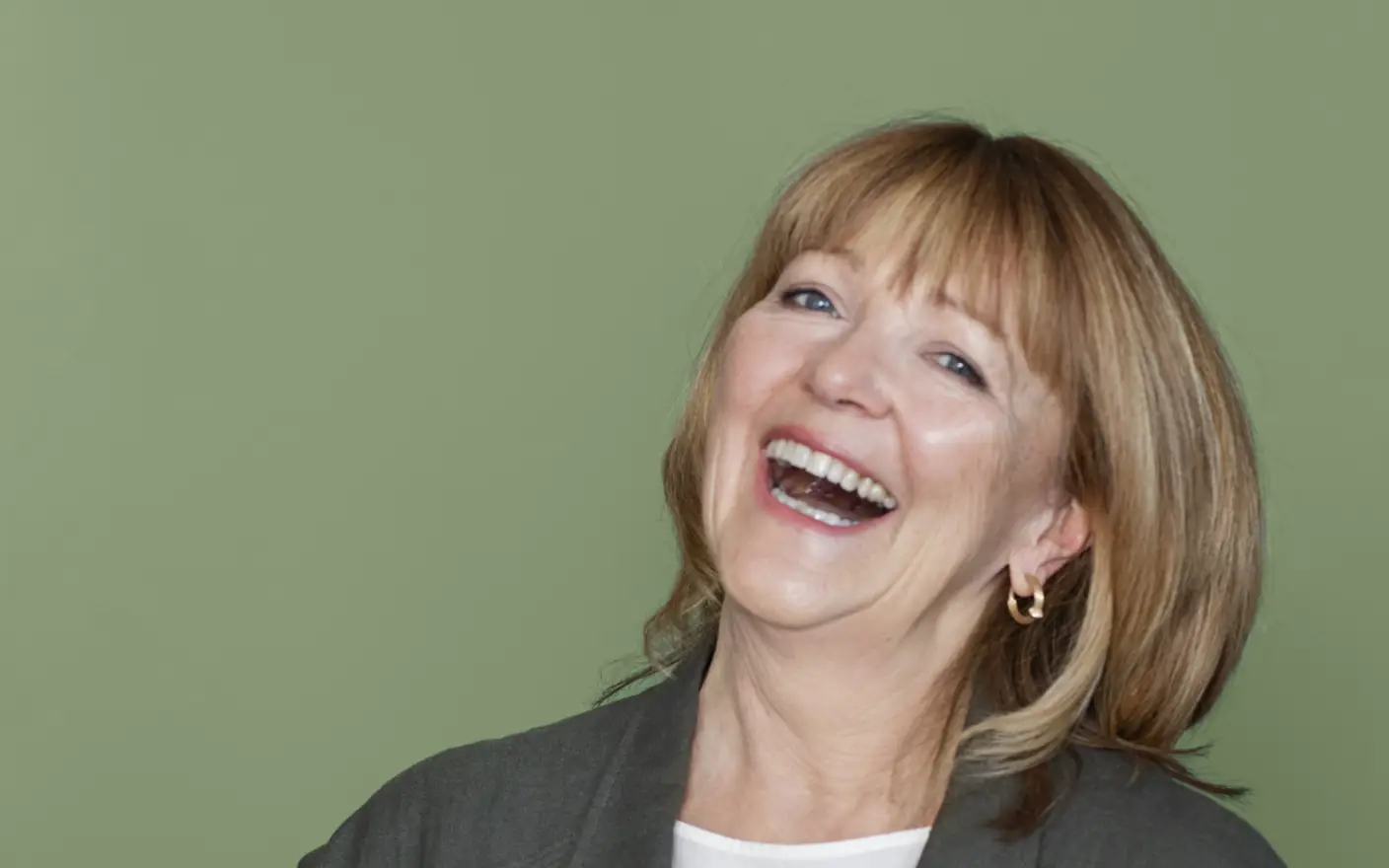 Lisbeth Larsen, Global Colour Manager at Jotun, in front of a wall painted with Jotun Lady 0125 Palmetto