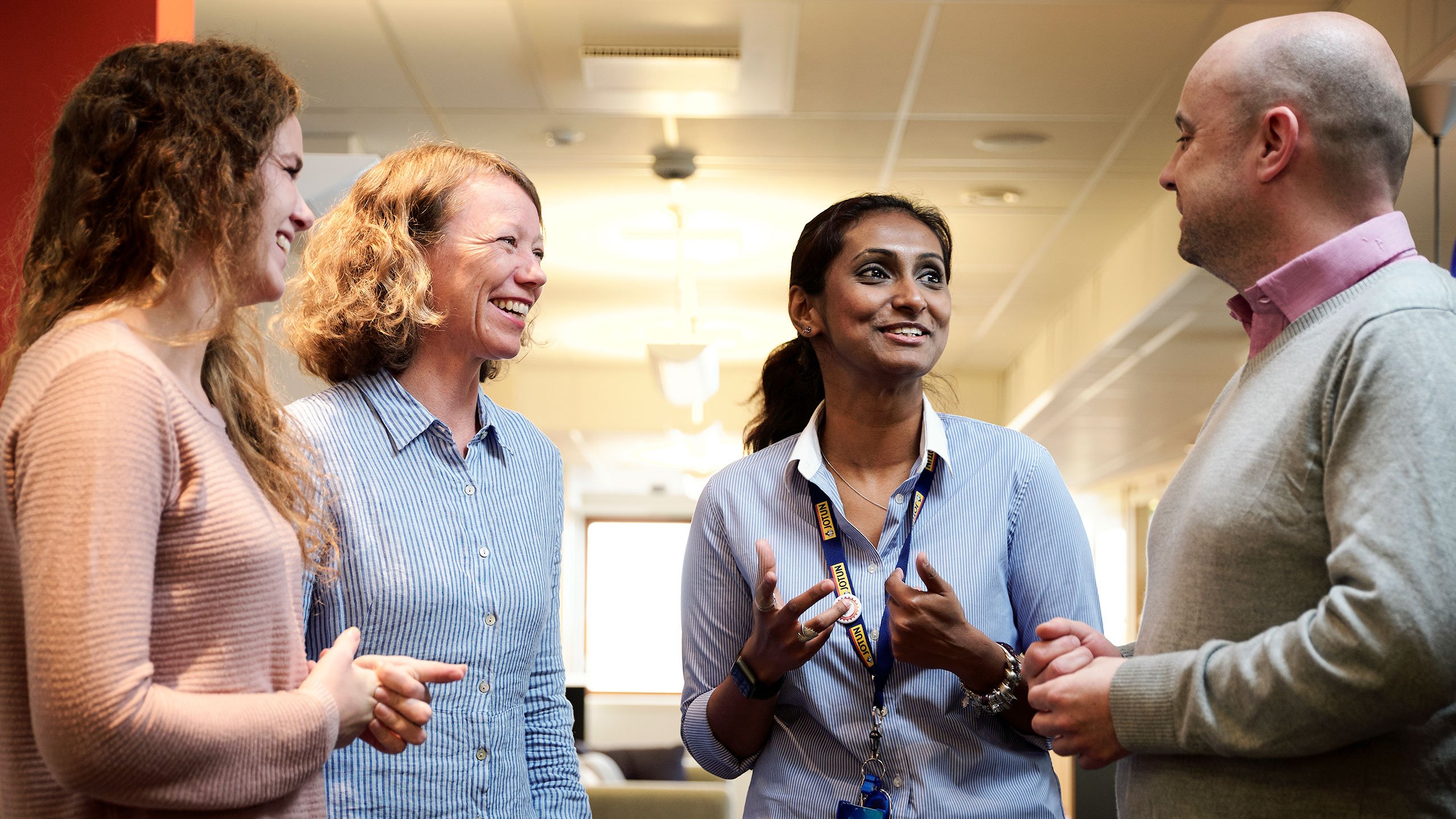 Four Jotun employees having a chat and laughing